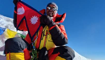 Climber on Everest with Nepali flag